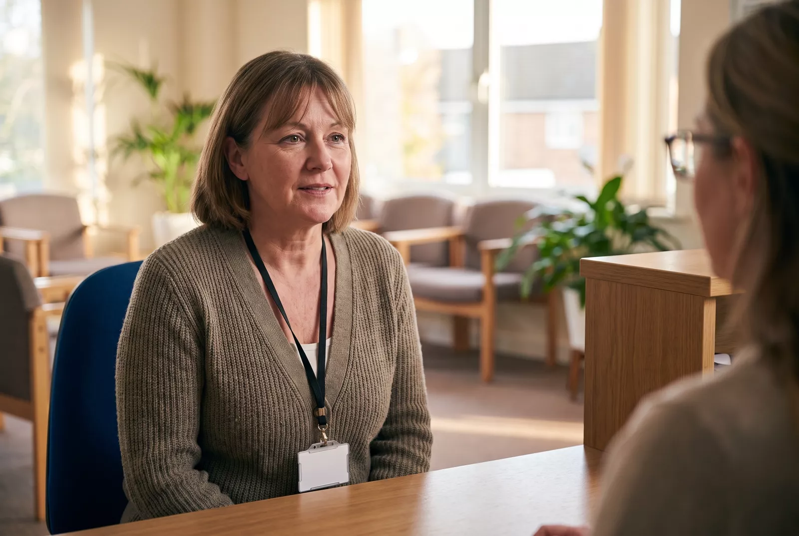 GP practice manager at a surgery reception desk