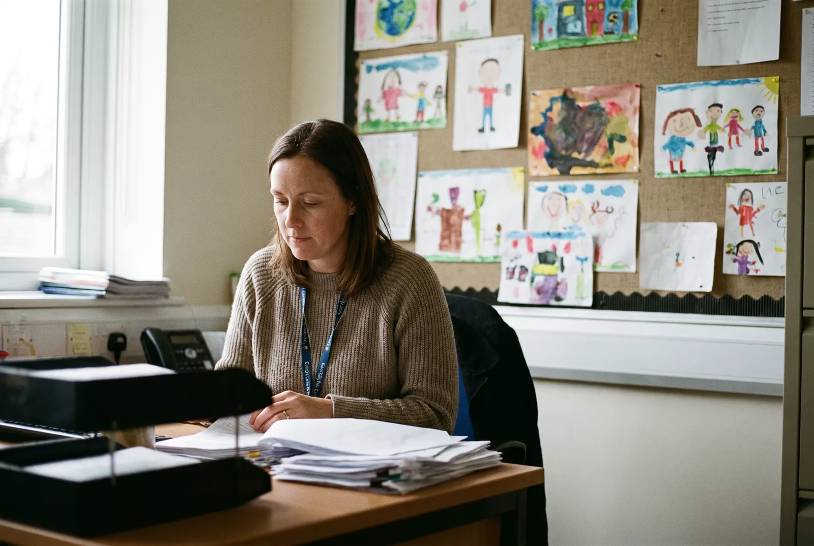 School business manager checking paperwork in the school office